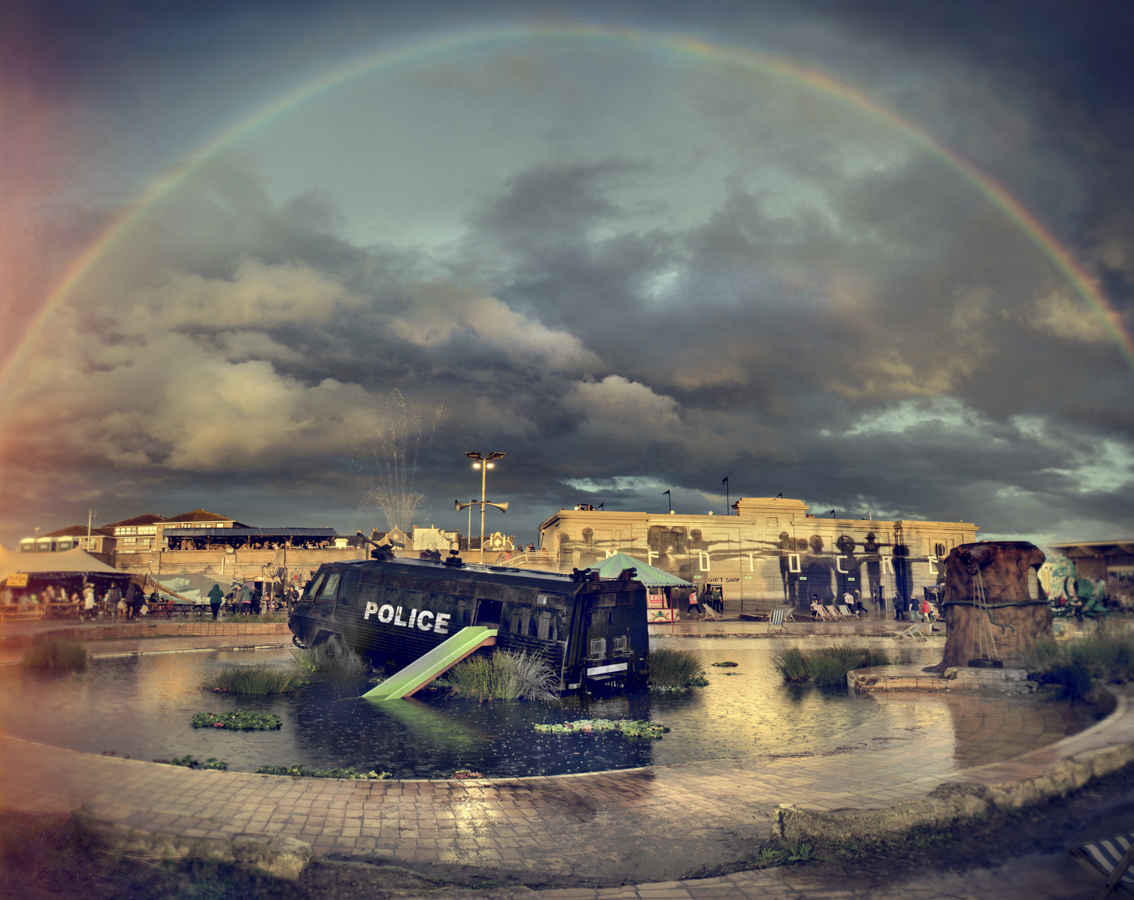 Barry Cawston's famous photo of a rainbow over the police van in a pond at Dismaland Weston-super-Mare
